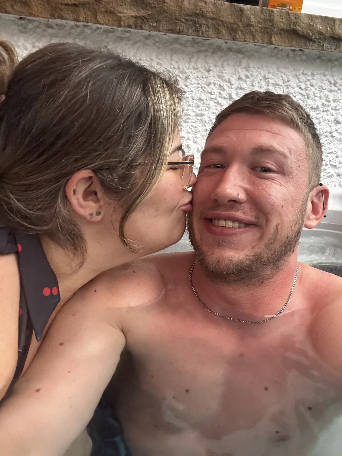 Nath and Alex in a hot tub, close and laughing